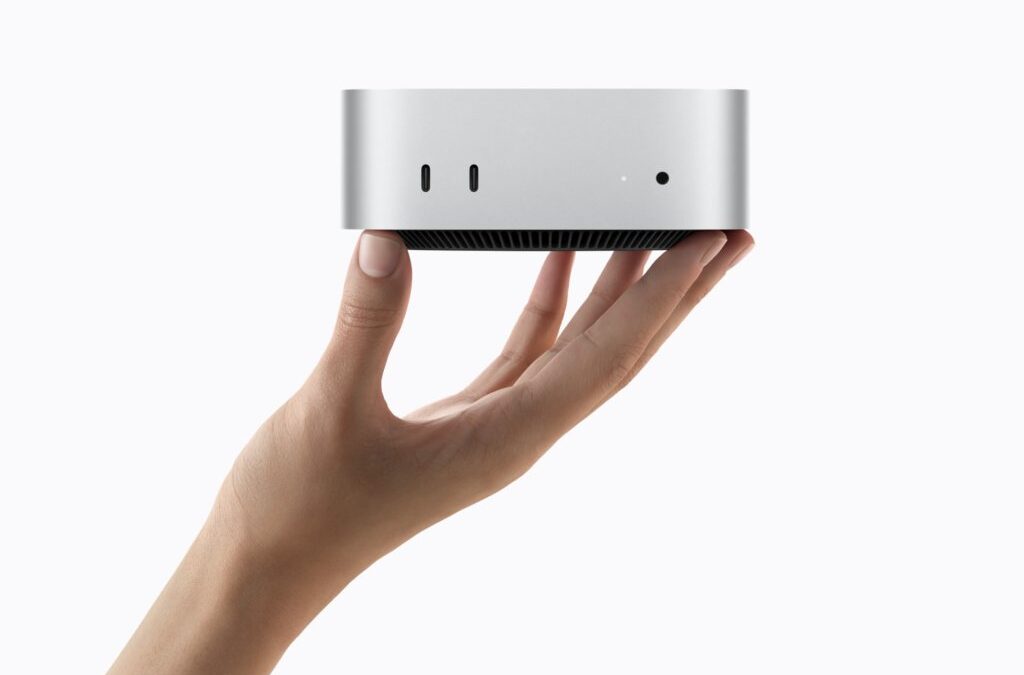 hand holding up Apple Mac Mini