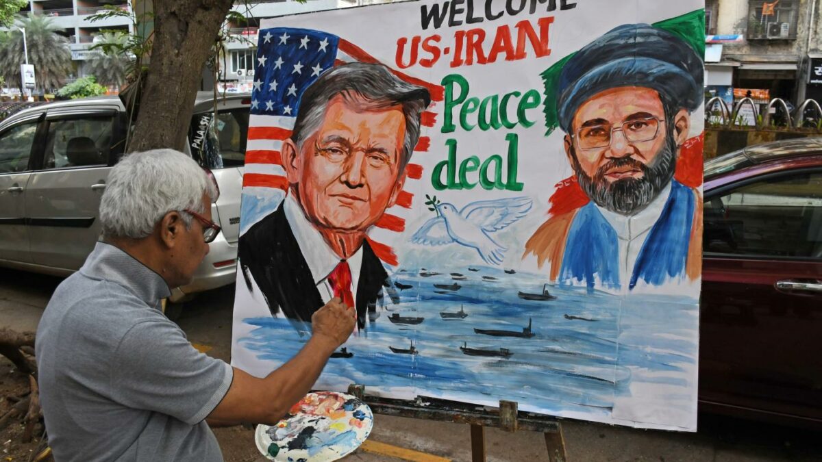 A teacher from the Gurukul School of Art paints a poster featuring U.S. President Donald Trump and Iran's Supreme Leader, Mojtaba Khamenei, welcoming the peace agreement between the U.S. and Iran.