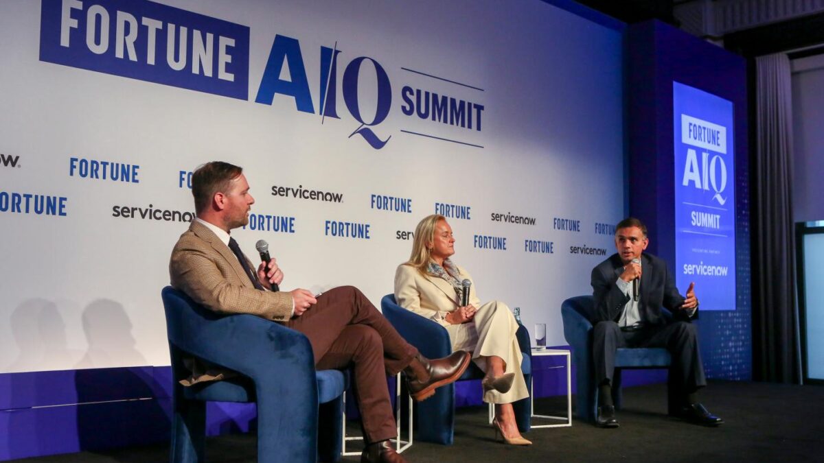Fortune's Andrew Nusca; Sally Moore, chief client officer and co-head of market intelligence at S&P Global; and Hari Gopalkrishnan, chief technology and information officer for Bank of America at the Fortune AIQ Summit on Oct. 1, 2026 at the New York Stock Exchange.