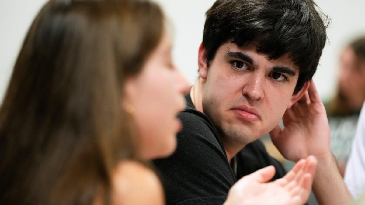 Michigan State University junior Julian Bautista, right, listens to a discussion at a campaign event for William Lawrence, the Democratic candidate for U.S. House of Representatives in Michigan's 7th District, on Sept. 15, 2026, in East Lansing, Mich.