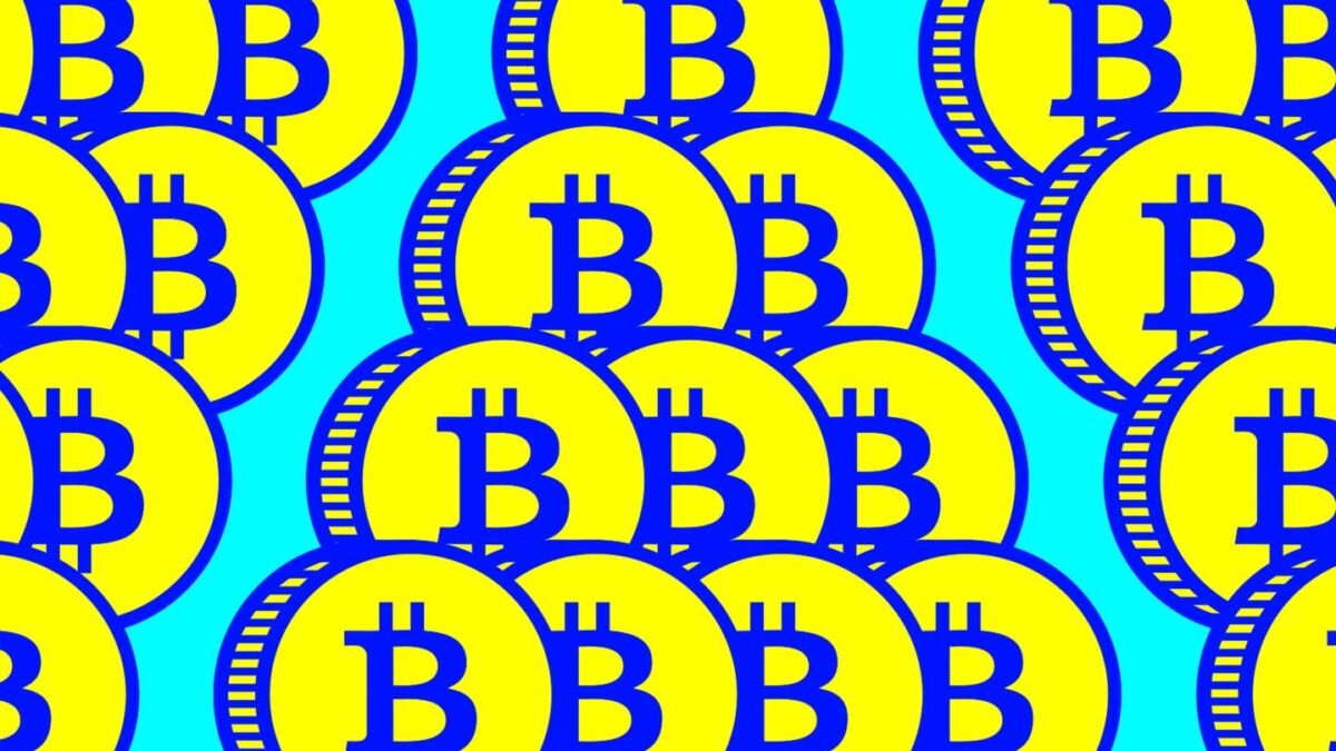 A stack of coins with the Bitcoin logo on them.