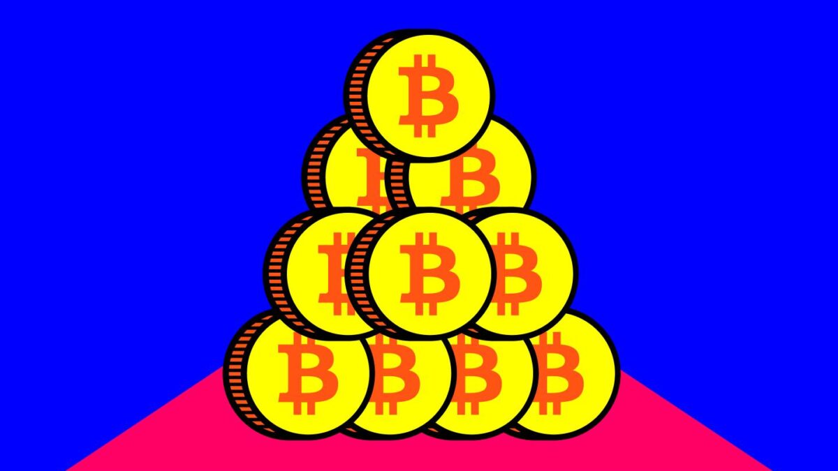 A tower of coins with the Bitcoin logo on them.
