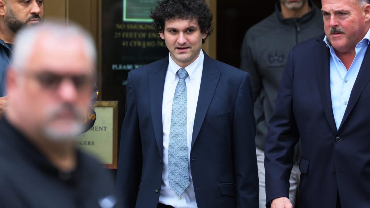 Sam Bankman-Fried walks outside a Manhattan courthouse.