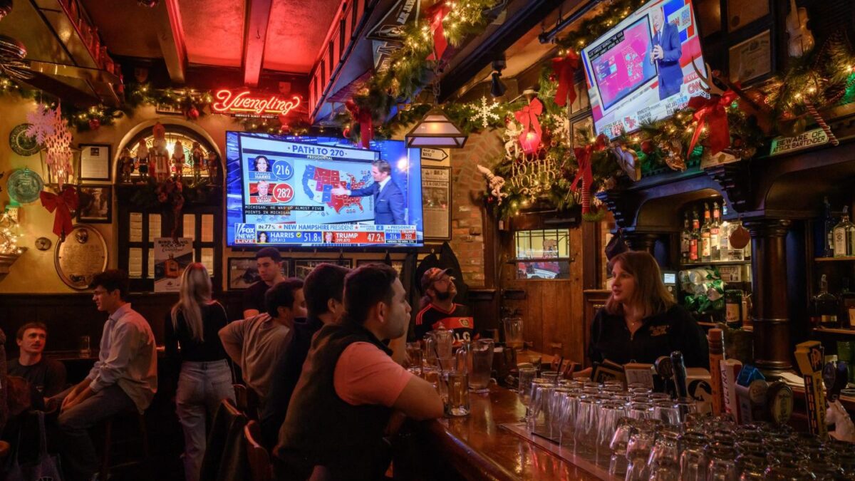 Patrons watch coverage of the 2024 presidential election at a bar in Philadelphia. A new Reuters/Ipsos poll finds 60% of Americans oppose betting on election results.