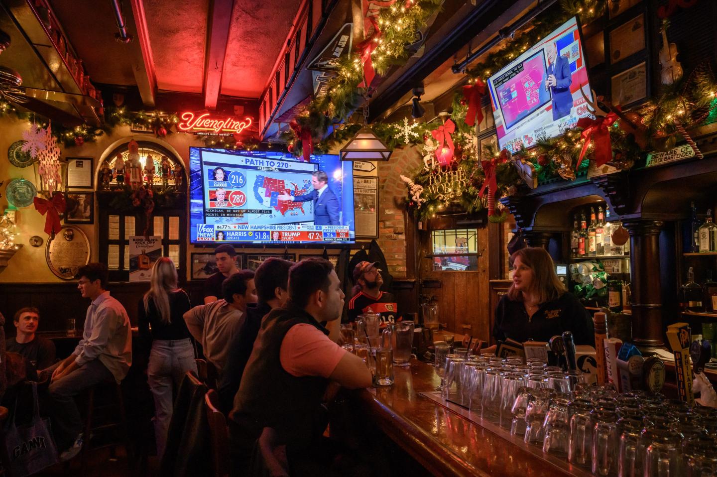 Patrons watch coverage of the 2024 presidential election at a bar in Philadelphia. A new Reuters/Ipsos poll finds 60% of Americans oppose betting on election results.