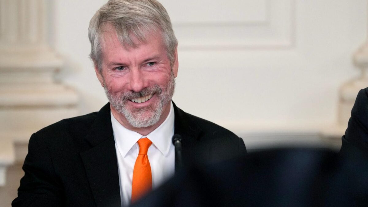 Michael Saylor smiles at the camera during a White House media event.