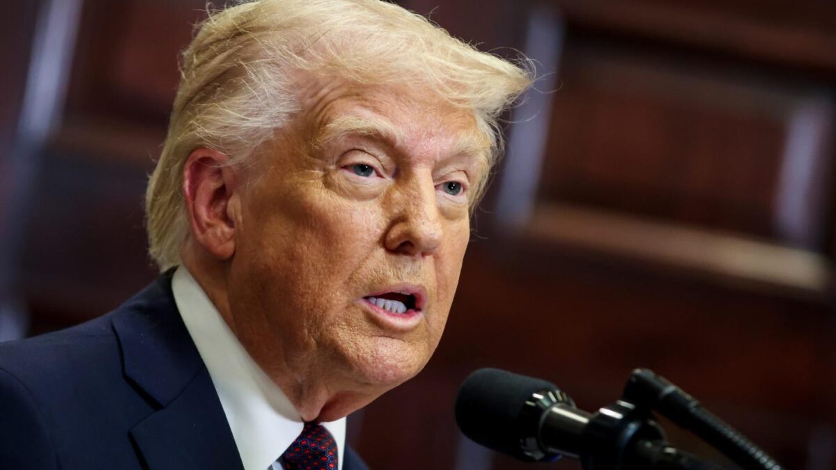 Donald Trump speaks at a podium in late March.