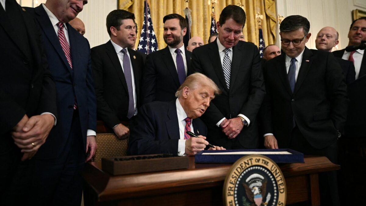 US President Donald Trump signs the GENIUS Act (Guiding and Establishing National Innovation for US Stablecoins Act), which codifies the use of stablecoins -- cryptocurrencies pegged to stable assets like the US dollar or US bonds -- in the East Room of the White House in Washington, DC, on July 18, 2025.