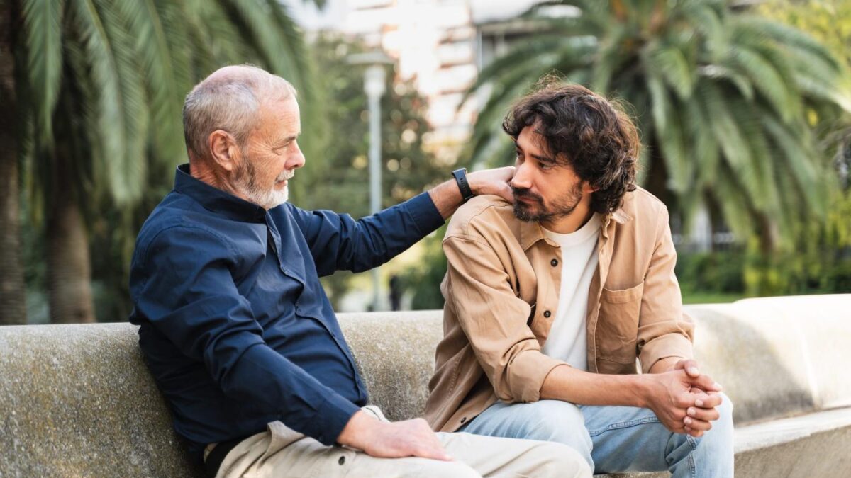 A father and son sitting together, talking