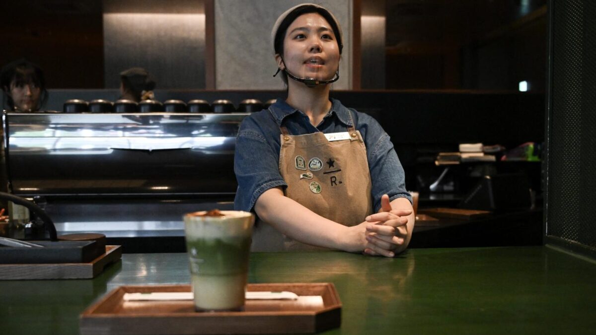 An employee stands behind a counter at a Starbucks coffee shop in Seoul on May 19, 2026.