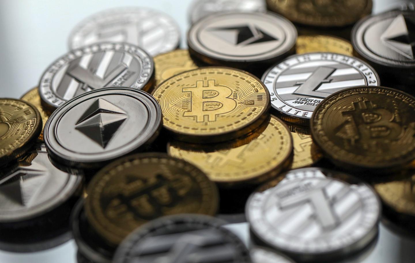 A display of physically cryptocurrencies including Bitcoin, Ethereum and Tether.